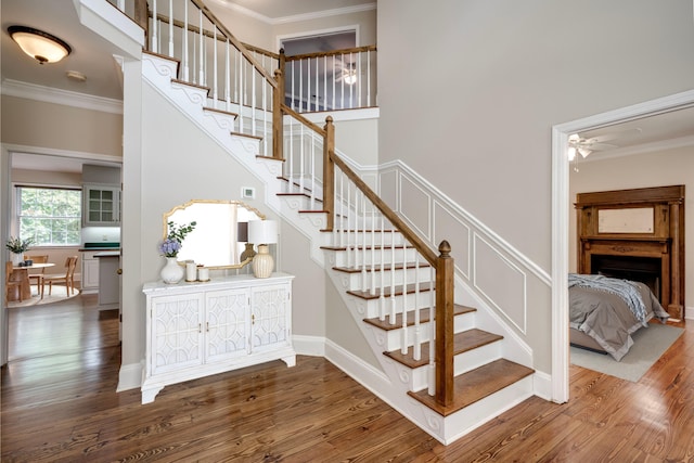 4142 Rivermont Dr, Evans, GA 30809 - stairs with ornamental molding, wood finished floors, and a ceiling fan