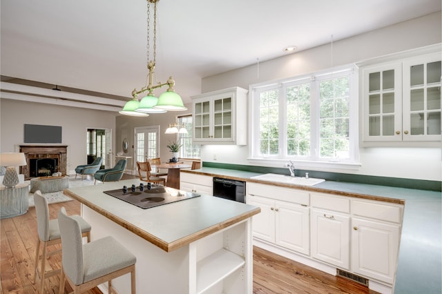 4142 Rivermont Dr, Evans, GA 30809 - kitchen featuring electric cooktop, light wood-style floors, a center island, black dishwasher, and white cabinetry