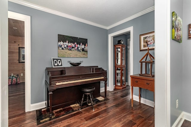 misc room with dark wood-type flooring and ornamental molding