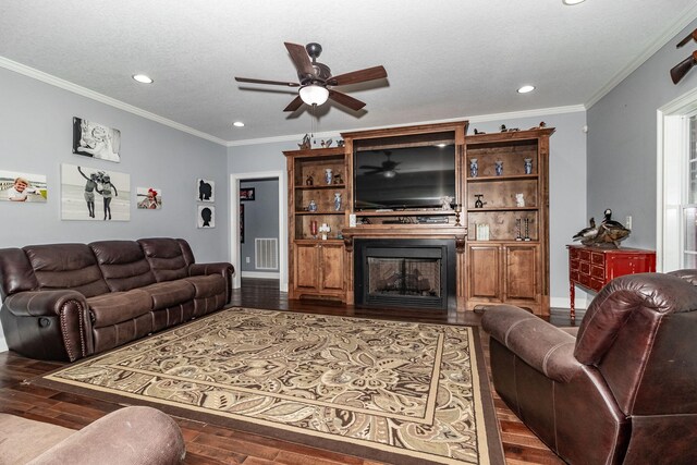 living room with a textured ceiling, crown molding, ceiling fan, and dark hardwood / wood-style floors