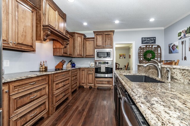 kitchen featuring sink, light stone counters, dark hardwood / wood-style floors, crown molding, and appliances with stainless steel finishes