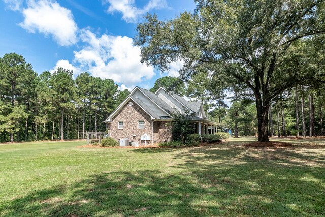 view of side of home with a yard