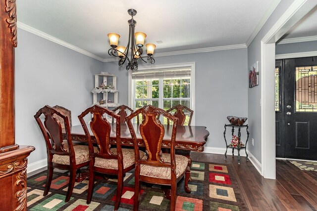 dining area with a notable chandelier, ornamental molding, and dark wood-type flooring