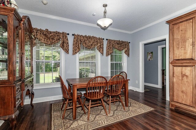 dining room featuring dark hardwood / wood-style flooring and ornamental molding