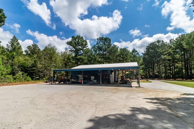 view of parking / parking lot featuring a carport