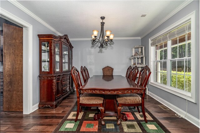 dining space featuring dark hardwood / wood-style flooring, crown molding, and an inviting chandelier