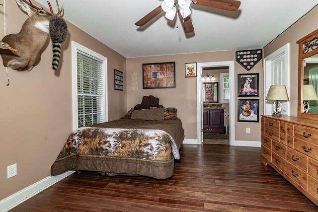 bedroom featuring multiple windows, ensuite bath, ceiling fan, and dark wood-type flooring