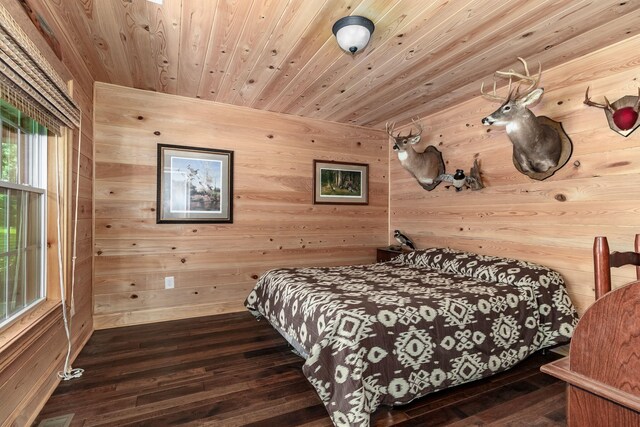 bedroom featuring wood ceiling, dark wood-type flooring, and wooden walls