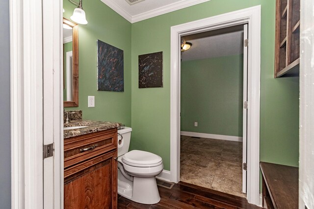 bathroom featuring vanity, toilet, and ornamental molding