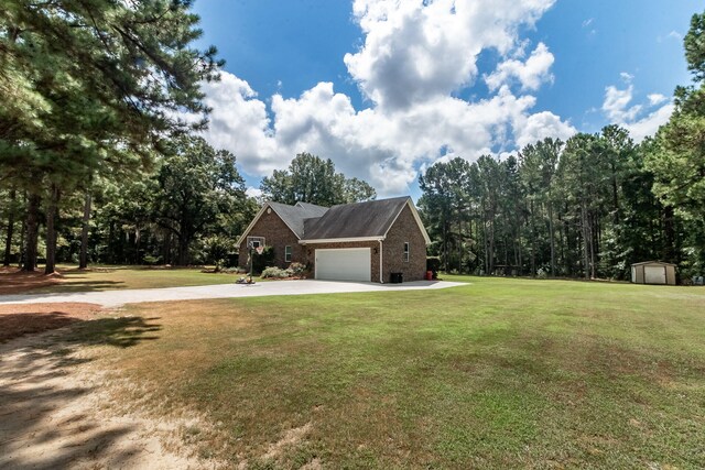 view of front of house featuring a front lawn, a storage unit, and a garage