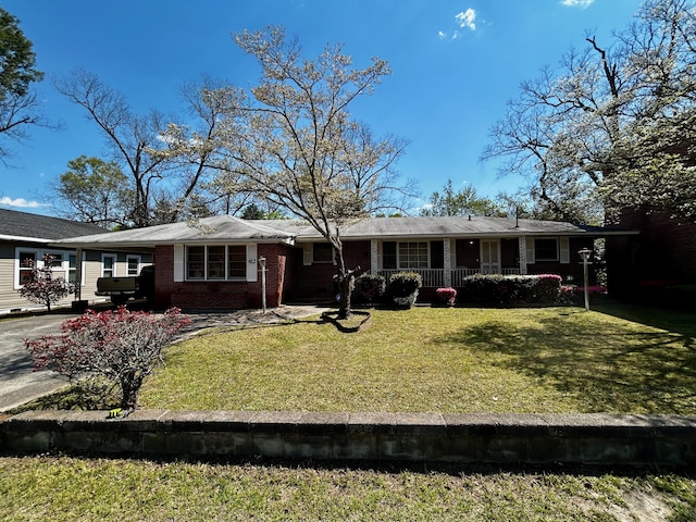 412 W 9th St, Waynesboro, GA 30830 - rear view of property featuring covered porch, brick siding, and a yard