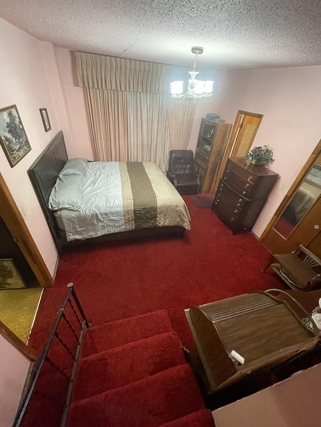 412 W 9th St, Waynesboro, GA 30830 - bedroom featuring carpet floors, a textured ceiling, and a chandelier