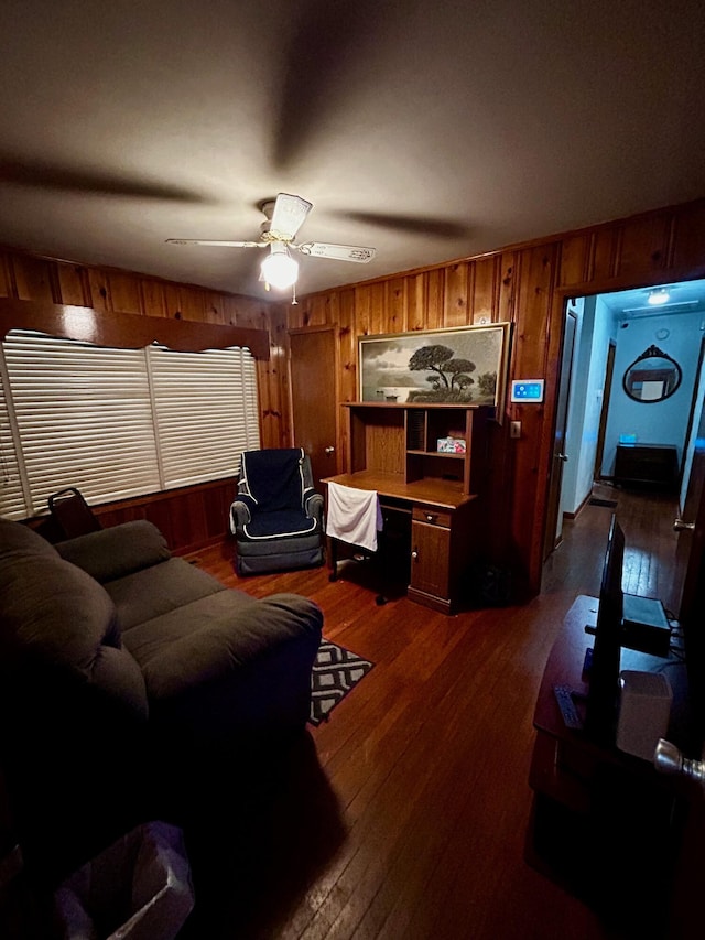 412 W 9th St, Waynesboro, GA 30830 - living area featuring wooden walls, ceiling fan, and dark wood-type flooring