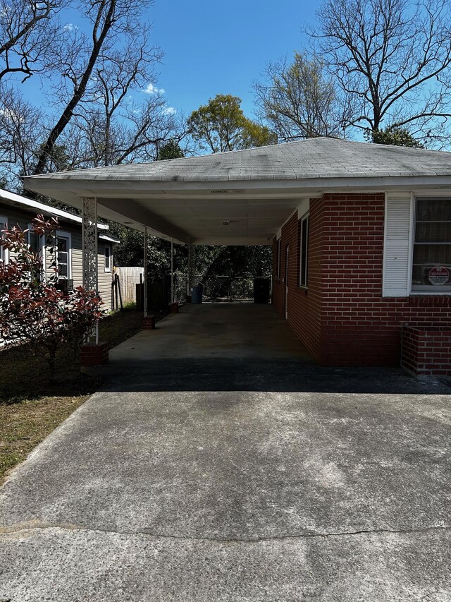 412 W 9th St, Waynesboro, GA 30830 - view of parking featuring an attached carport and concrete driveway