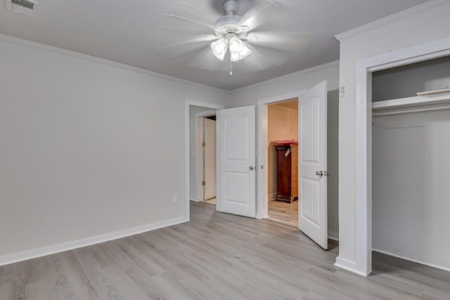 unfurnished bedroom with a closet, visible vents, light wood-type flooring, and crown molding