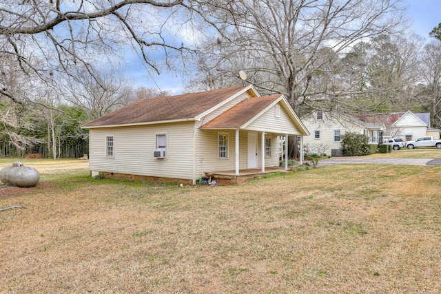 view of front of house with a front yard, cooling unit, a porch, a shingled roof, and crawl space