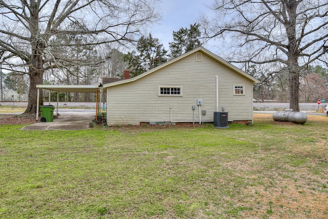 view of home's exterior featuring an attached carport, central air condition unit, and a lawn