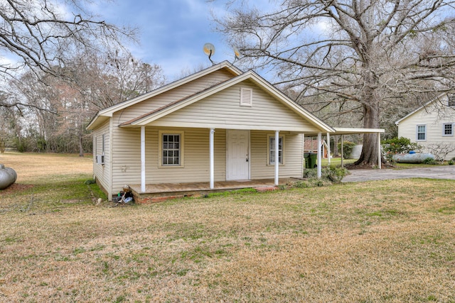 bungalow-style home featuring covered porch and a front lawn