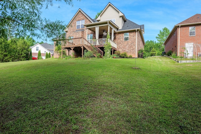 back of house featuring a yard, brick siding, stairway, a ceiling fan, and a wooden deck