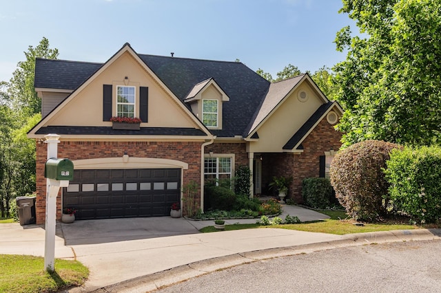 traditional-style house with driveway and brick siding