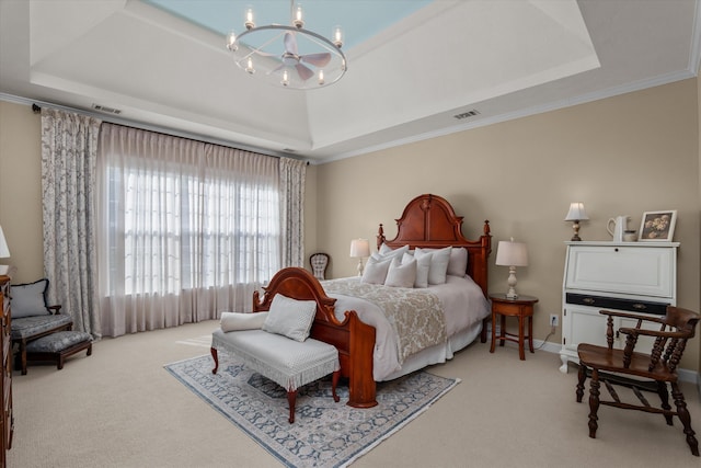 bedroom featuring a tray ceiling, a chandelier, carpet, and ornamental molding