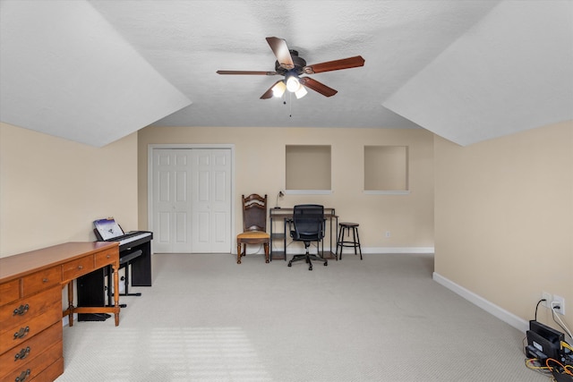 office featuring light colored carpet, a ceiling fan, and baseboards
