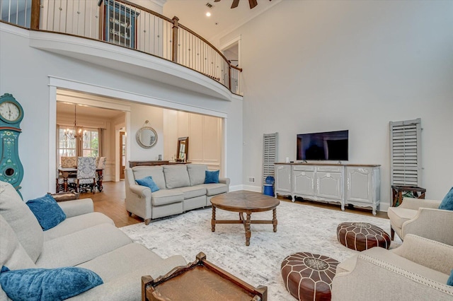 649 Bent Creek Dr, Evans, GA 30809 - living room with an inviting chandelier, a high ceiling, wood finished floors, and baseboards