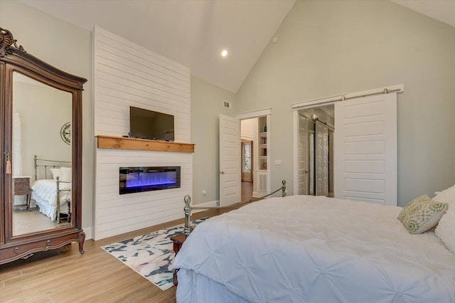 649 Bent Creek Dr, Evans, GA 30809 - bedroom featuring a fireplace, recessed lighting, wood finished floors, and high vaulted ceiling