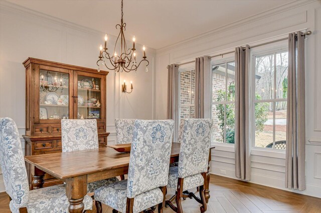 649 Bent Creek Dr, Evans, GA 30809 - dining space with a notable chandelier, a decorative wall, a healthy amount of sunlight, and crown molding