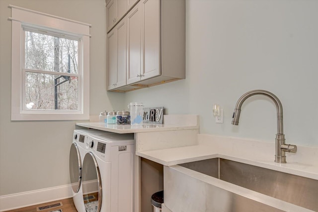 649 Bent Creek Dr, Evans, GA 30809 - laundry room with baseboards, visible vents, cabinet space, a sink, and washing machine and dryer