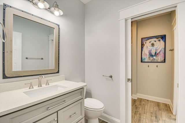 649 Bent Creek Dr, Evans, GA 30809 - bathroom with vanity, toilet, wood finished floors, and baseboards
