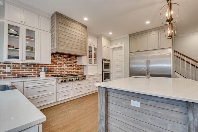 649 Bent Creek Dr, Evans, GA 30809 - kitchen with light wood-type flooring, a sink, tasteful backsplash, white cabinetry, and stainless steel appliances