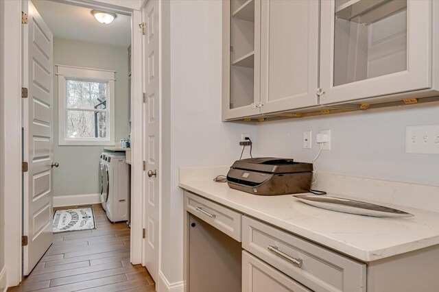 649 Bent Creek Dr, Evans, GA 30809 - kitchen with light stone counters, baseboards, light wood finished floors, glass insert cabinets, and washer and dryer