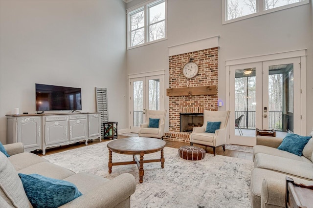 649 Bent Creek Dr, Evans, GA 30809 - living area featuring a wealth of natural light, french doors, a brick fireplace, and wood finished floors