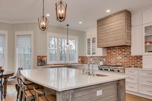 649 Bent Creek Dr, Evans, GA 30809 - kitchen featuring light wood-style flooring, tasteful backsplash, white cabinetry, stainless steel gas stovetop, and crown molding