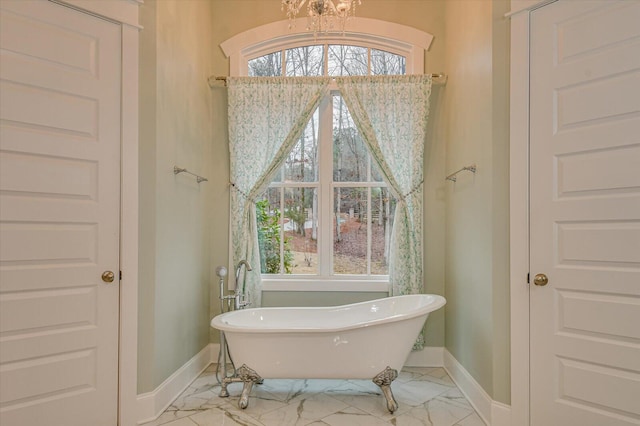 649 Bent Creek Dr, Evans, GA 30809 - bathroom featuring a soaking tub, baseboards, marble finish floor, and a chandelier