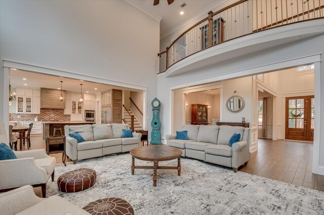 649 Bent Creek Dr, Evans, GA 30809 - living area featuring stairway, a high ceiling, wood finished floors, and ornamental molding