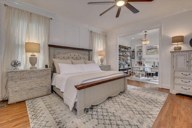 704 Summergate Ct, Augusta, GA 30909 - bedroom with crown molding, light wood finished floors, a chandelier, and ceiling fan