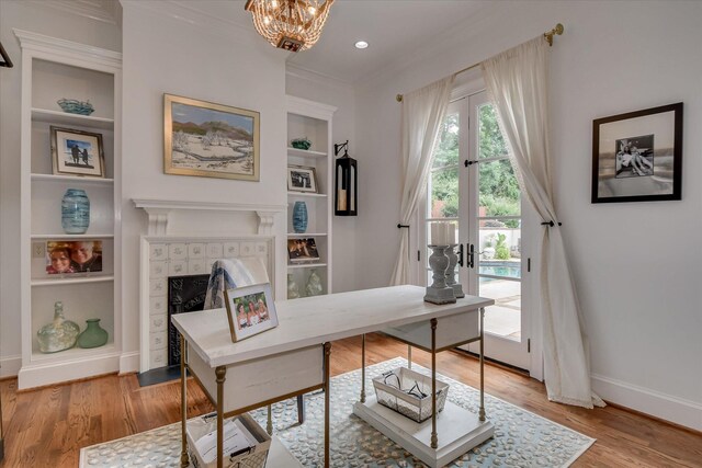 704 Summergate Ct, Augusta, GA 30909 - office space with built in features, a tile fireplace, ornamental molding, light wood-style floors, and a chandelier