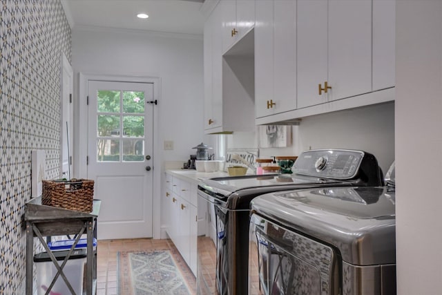 704 Summergate Ct, Augusta, GA 30909 - laundry area featuring washing machine and clothes dryer, cabinet space, ornamental molding, and light tile patterned floors