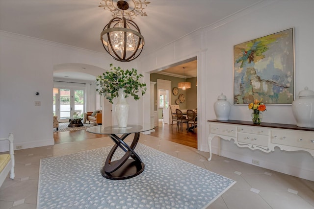 704 Summergate Ct, Augusta, GA 30909 - tiled foyer featuring a chandelier, ornamental molding, and arched walkways