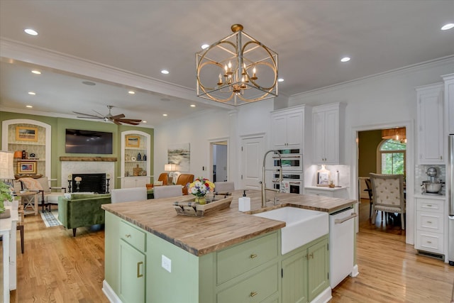 704 Summergate Ct, Augusta, GA 30909 - kitchen with butcher block counters, green cabinetry, white appliances, a fireplace, and ceiling fan