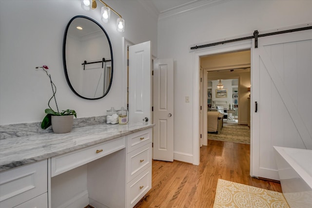 704 Summergate Ct, Augusta, GA 30909 - bathroom with ornamental molding, wood finished floors, a freestanding bath, and vanity