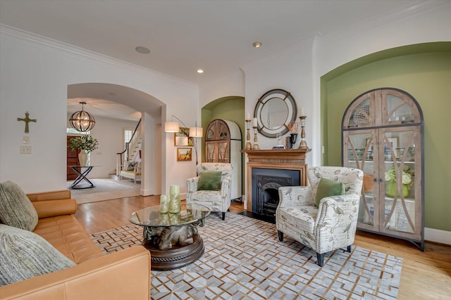 704 Summergate Ct, Augusta, GA 30909 - living area featuring crown molding, wood finished floors, a fireplace, and arched walkways