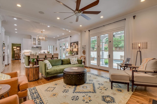 704 Summergate Ct, Augusta, GA 30909 - living area with ornamental molding, ceiling fan, light wood finished floors, a chandelier, and french doors