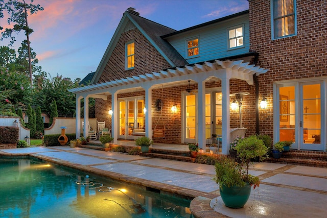 704 Summergate Ct, Augusta, GA 30909 - back of property at dusk with brick siding, french doors, and a patio