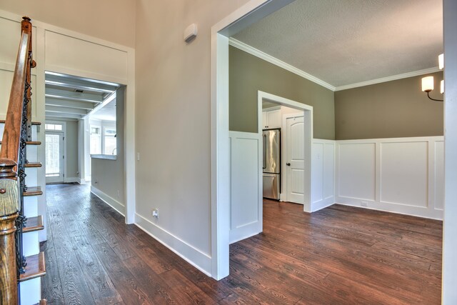 corridor featuring dark hardwood / wood-style floors and crown molding