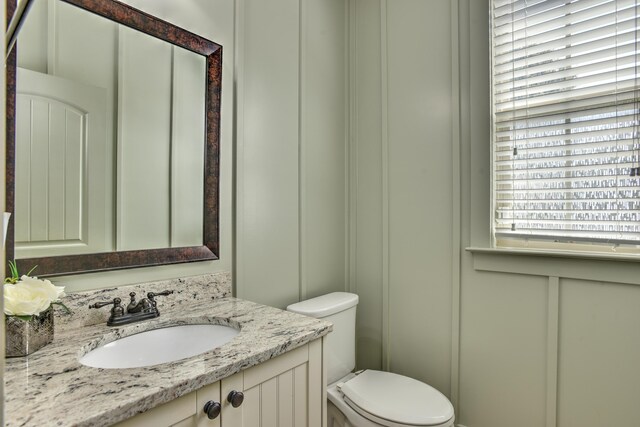 bathroom featuring vanity and toilet