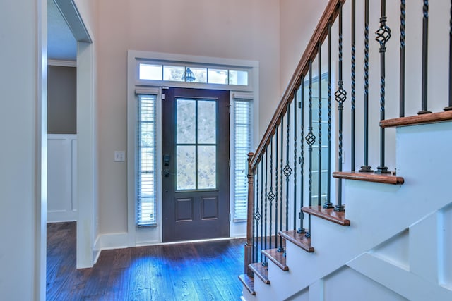 foyer featuring dark wood-type flooring and ornamental molding