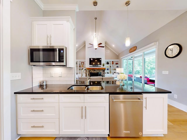 243 Walton Heath Way, Aiken, SC 29803 - kitchen featuring appliances with stainless steel finishes, a sink, ceiling fan, dark stone countertops, and white cabinets